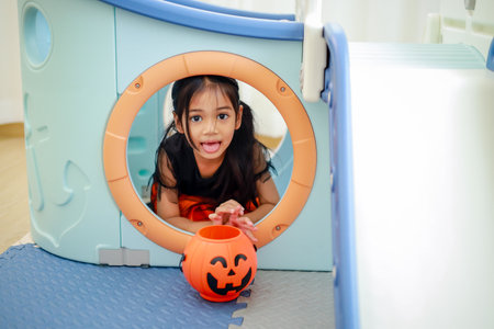 Halloween, holiday and childhood concept. Little kids southeast asian on halloween dressed in a witch costume.の写真素材