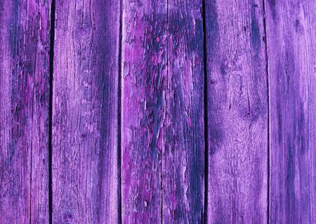 Old wood. Background of old violet board and cracked paint.の写真素材