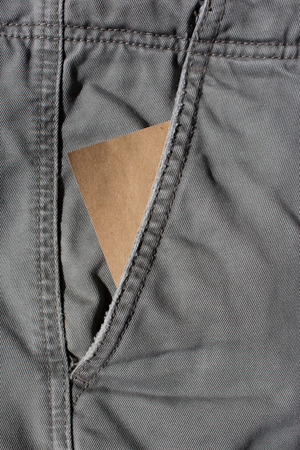 blank paper in old canvas trousers pocketの写真素材