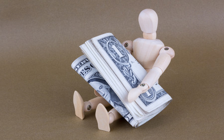 sitting mannequin with dollarの写真素材