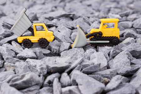 dumper truck and bulldozer on pebbles