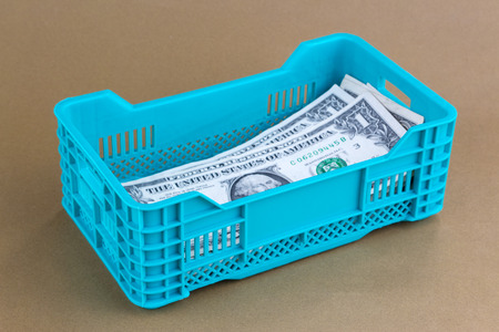 Moneys in a plastic crate
