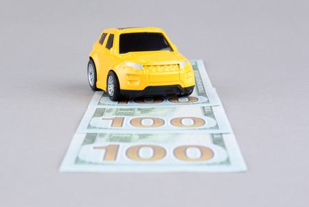 Toy car on moneyの写真素材