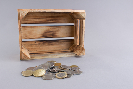 Coins and wooden crateの写真素材