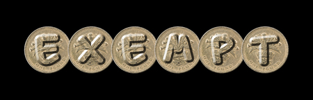 EXEMPT - One pound coins on black background