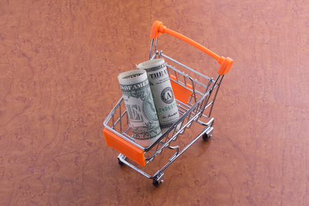 One Dollar paper currency in the shopping cartの写真素材
