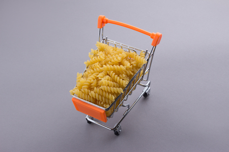 Macaroni pasta in shopping cartの写真素材