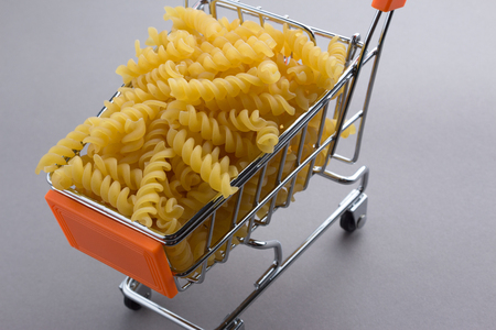 Macaroni pasta in shopping cartの写真素材