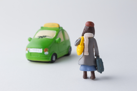 Miniature girl with taxi carの写真素材