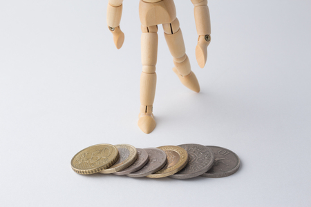 Stack of coins with wooden dummyの写真素材
