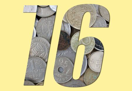 Number 16 with stack of old coins on yellow backgroundの写真素材