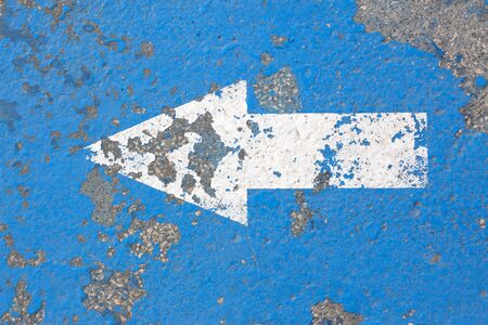 white arrow sign on road
