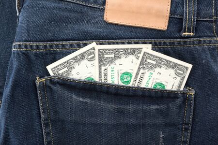 Dollar money in jeans pocket