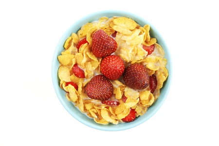 A mixture of strawberry, milk and cornflakes in e blue bowl