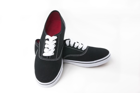 Black canvas shoes with white shoelaces on white backgroundの写真素材