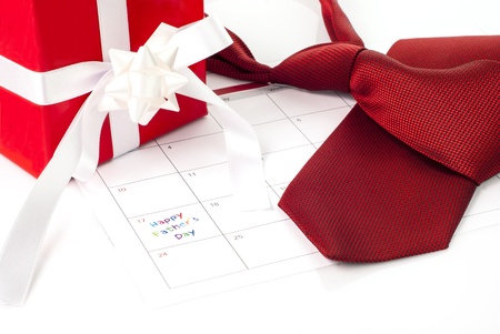 Red tie, gift box and calendar showing fathers dayの写真素材