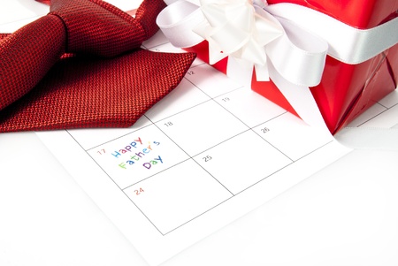 Red tie, gift box and calendar showing fathers dayの写真素材