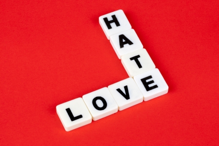 love and hate words on red backgroundの写真素材