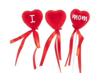 Three red hearts with red ribbons on white backgroundの写真素材