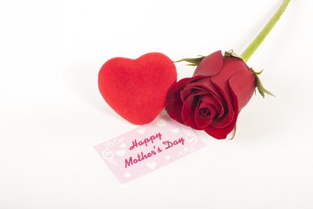 Red rose bud and red heart with mothers day cardの写真素材