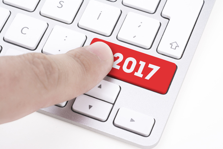 finger pressing keyboard key written 2017 new yearの写真素材