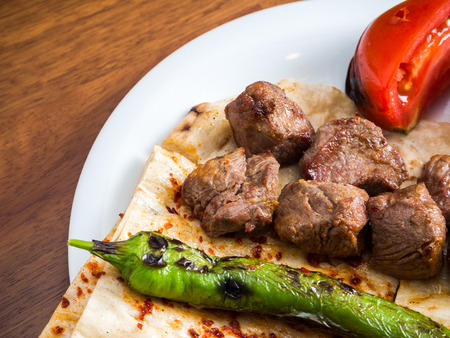 Lamb kebabs with flatbread, tomato and pepperの写真素材