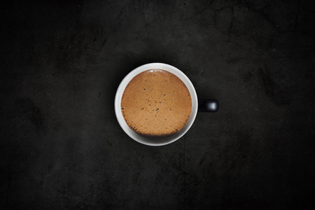 coffee in black and white mug on dark stone backgroundの写真素材