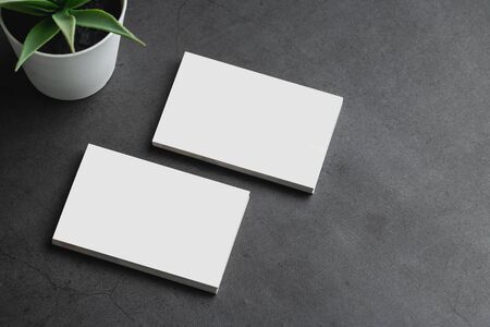 Empty business cards. Mockup for branding identity on dark stone background