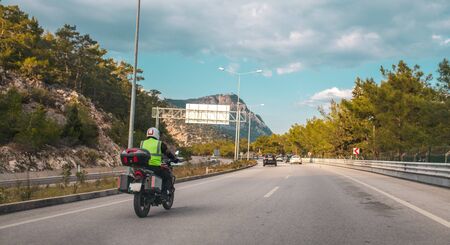 Male motorbike rider on his motorbike on the highwayの写真素材