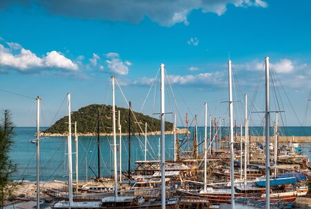 Wooden sailboats with masts in the harbor near the Sican Island on clear dayの写真素材