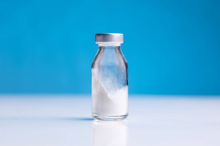 glass medical pharmaceutical sterile ampule bottle with powder medicine for injection isolated on...