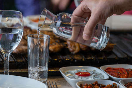 Different types of meat grilled on Barbecue on the table, Served with special Turkish appetizers and Turkish raki.の写真素材