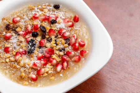 Traditional Turkish Dessert is Asure Noah's Pudding on wooden background