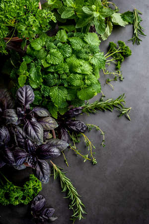 Mixed fresh green vegetables on wooden backgroundの写真素材