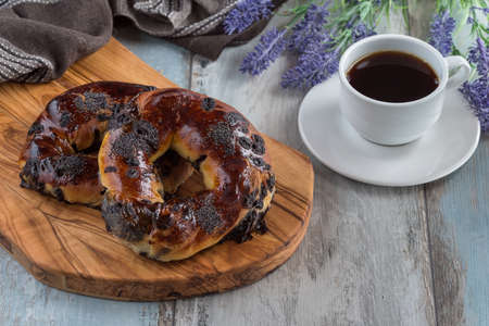 Turkish bagel acma with chocolate and tea on wooden background.