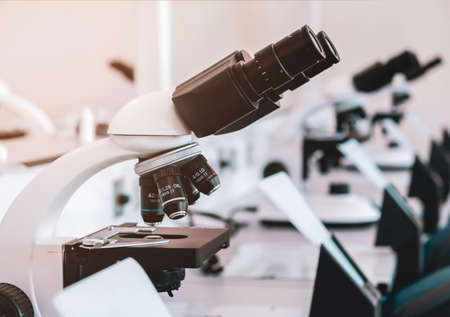 Microscope on table in the laboratory. Line of microscopes on tables in a hospital laboratory...
