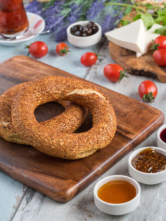 Turkish bagel and black Turkish tea on wooden table.