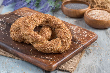 whole wheat Turkish bagels with sesame on wooden chopping board