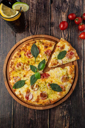 rustic italian pizza with mozzarella, cheese and basil leaves. top viewの写真素材