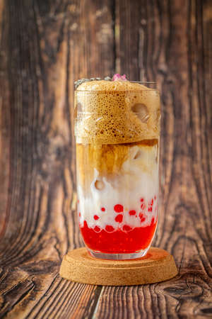 Fruity Bubble Tea in glass cup on wooden backgroundの写真素材