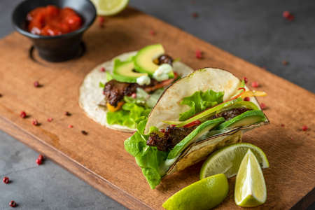 fresh taco with avocado on cutting boardの写真素材
