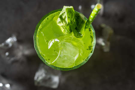 refreshing and light basil summer cocktail with ice cubes