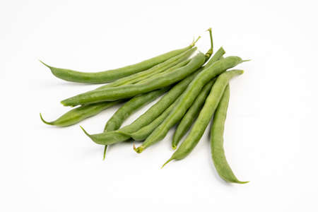 Pile of green french beans in isolated white background.の写真素材