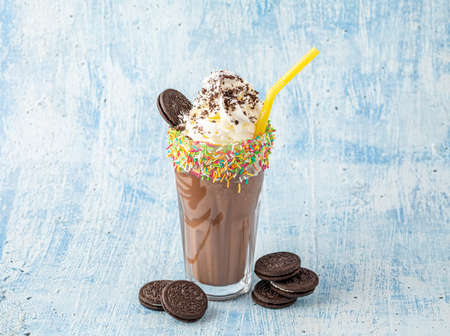 Cream and chocolate milkshake on blue backgroundの写真素材
