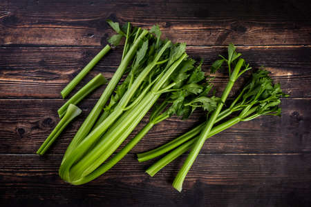 Bunch of fresh celery stalk with leaves on wooden backgroundの写真素材