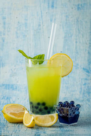 Lemonade with bubble tea on blue stone backgroundの写真素材
