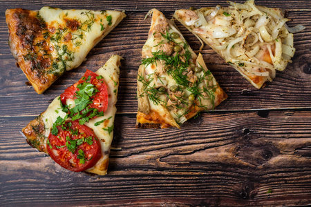 Assorted handmade Argentinian pizza on wooden background.の写真素材