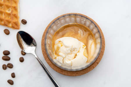 Affogato Coffee with vanilla ice cream in crystal glass on white marble tableの写真素材