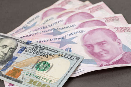 US dollars and Turkish Liras on top of each other completely covering the screen. 1 US dollar being equal to 10 Turkish Liras concept photo shootの写真素材