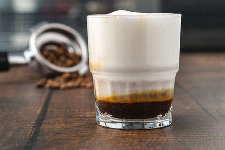 Cortado coffee with coffee beans next to it. Traditional coffee in Spain.